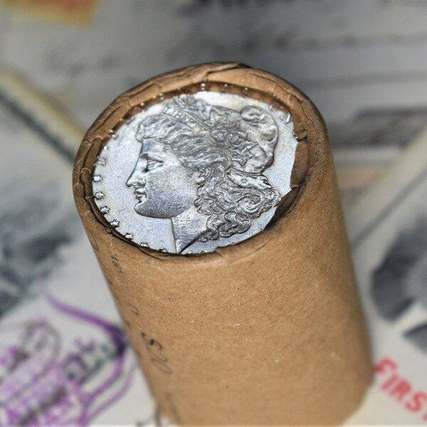 Morgan dollar-style coin in a paper roll; authenticity not independently verified